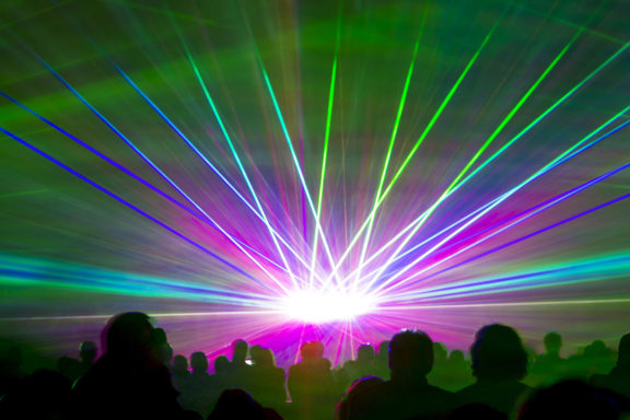 Laser Show Rays. Very Colorful Show With A Crowd Silhouette And